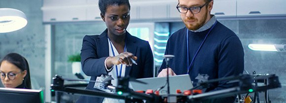 Image of two students sitting in front of computers